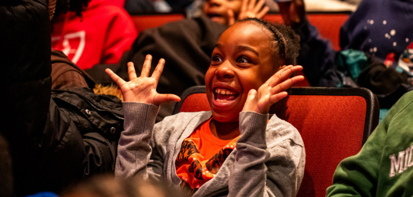 CT Website Wide_2 Happy elementary school age girl (jazz hands framing face)