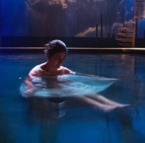 Actress Leigha Kato waits in the pool during a moment of rehearsal