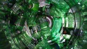 the bottom of a collection bin of soda bottles